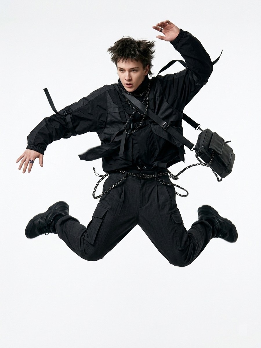 Dopameez cast — mid-air jump in an all-black layered fit