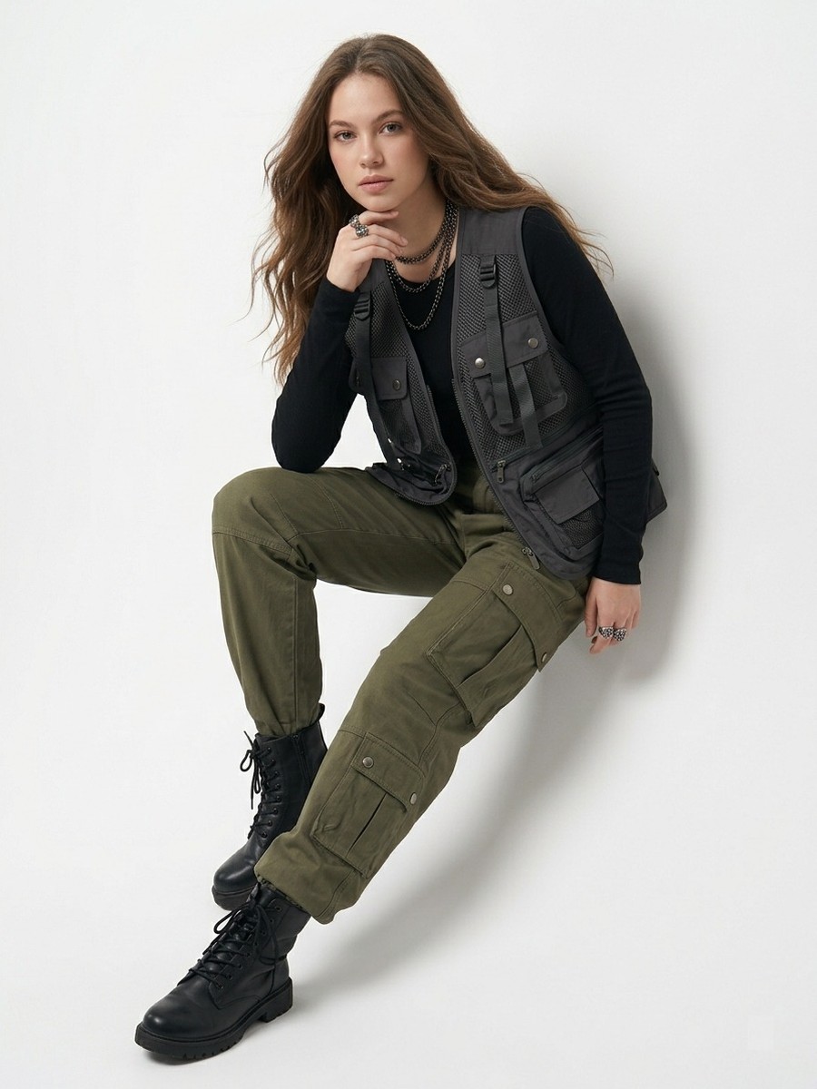 Dopameez cast — utility vest and cargo trousers, seated studio shot